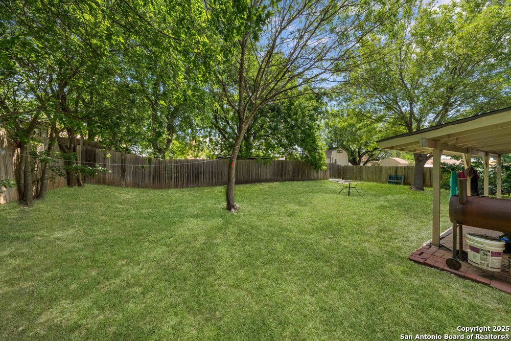 7131 Apache Converse, TX 78109 - Photo 13 of 14 a view of a backyard with a slide