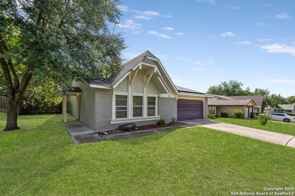 7131 Apache Converse, TX 78109 - Photo 2 of 14 a front view of house with yard and green space