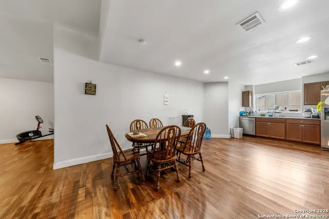 a view of a dining room with furniture and wooden floor