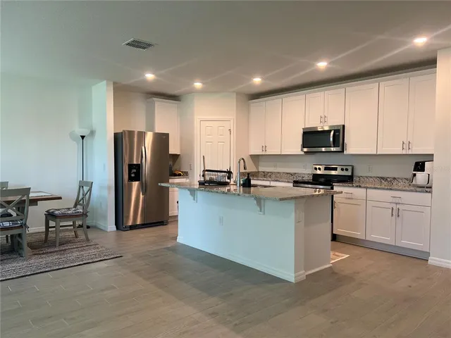 a kitchen with stainless steel appliances a refrigerator stove microwave and sink