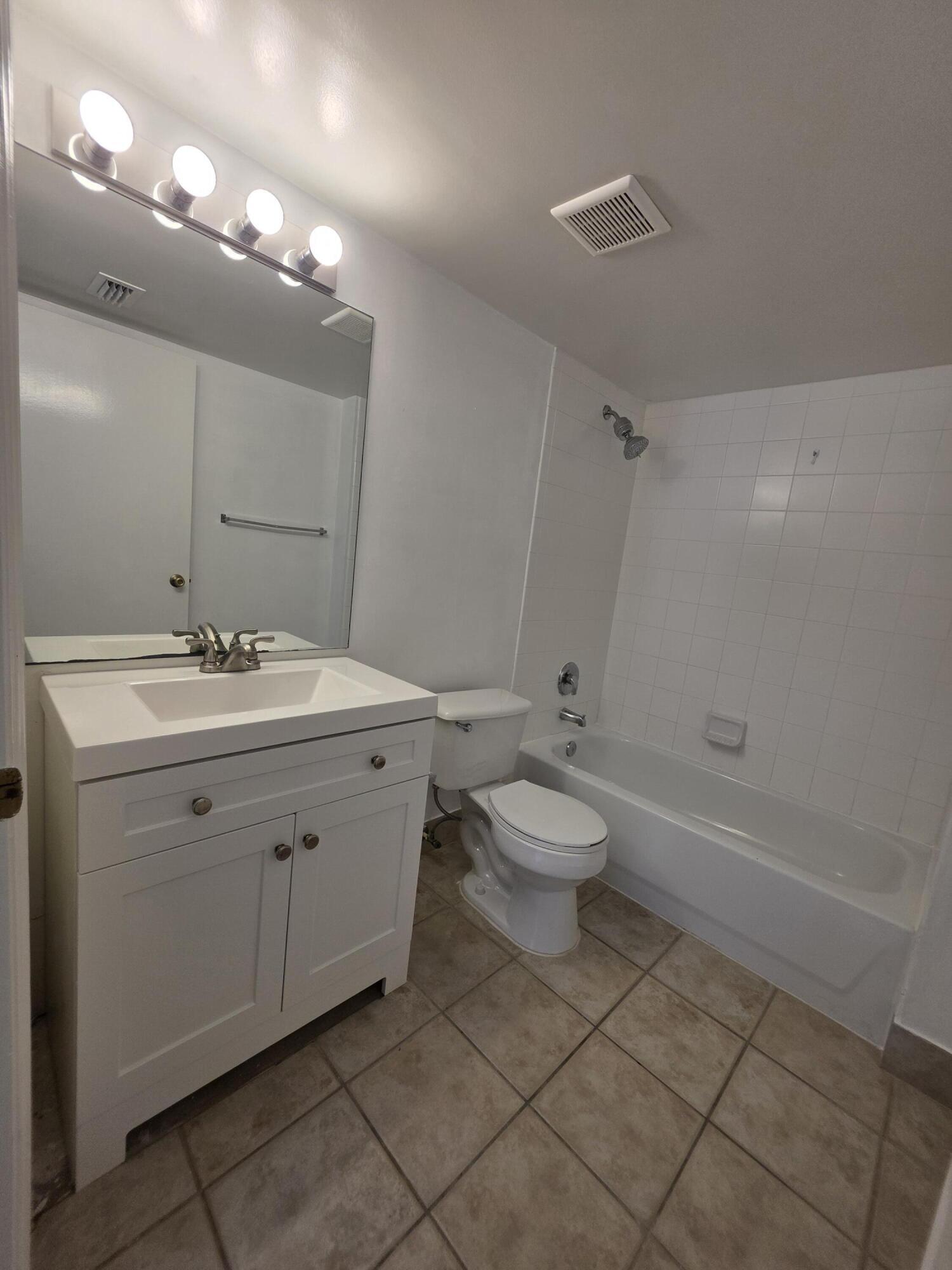 4175 Haverhill Road, Unit 907 West Palm Beach, FL 33417 - Photo 25 of 38 a bathroom with a sink toilet and shower
