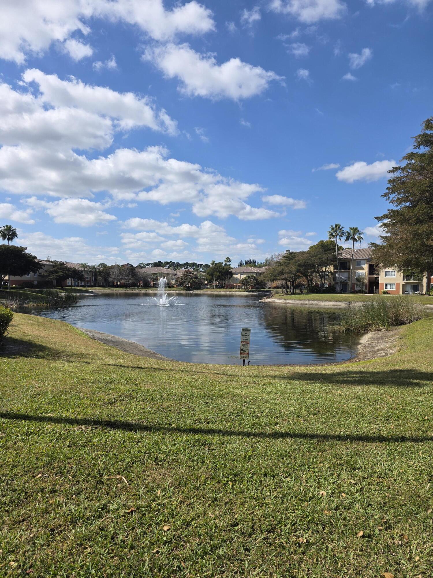 4175 Haverhill Road, Unit 907 West Palm Beach, FL 33417 - Photo 8 of 38 a view of a lake with houses in the background