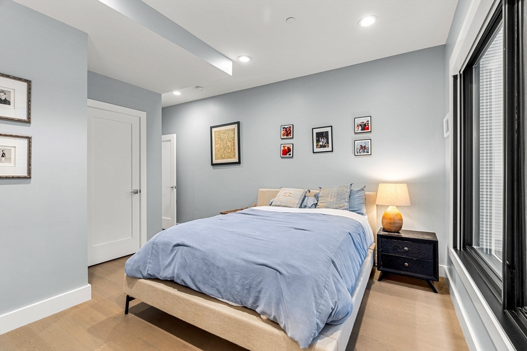 39 A Street, Unit 4 Boston, MA 02127 - Photo 12 of 28 a bedroom with a bed and a large mirror