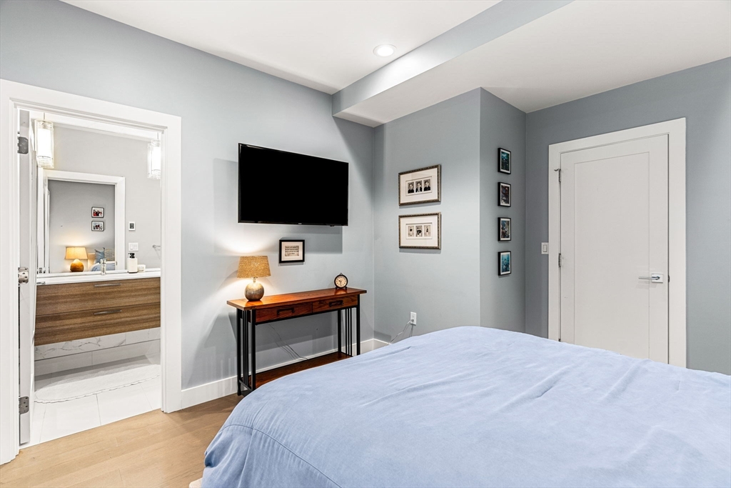 39 A Street, Unit 4 Boston, MA 02127 - Photo 13 of 28 a bedroom with a bed and a flat screen tv