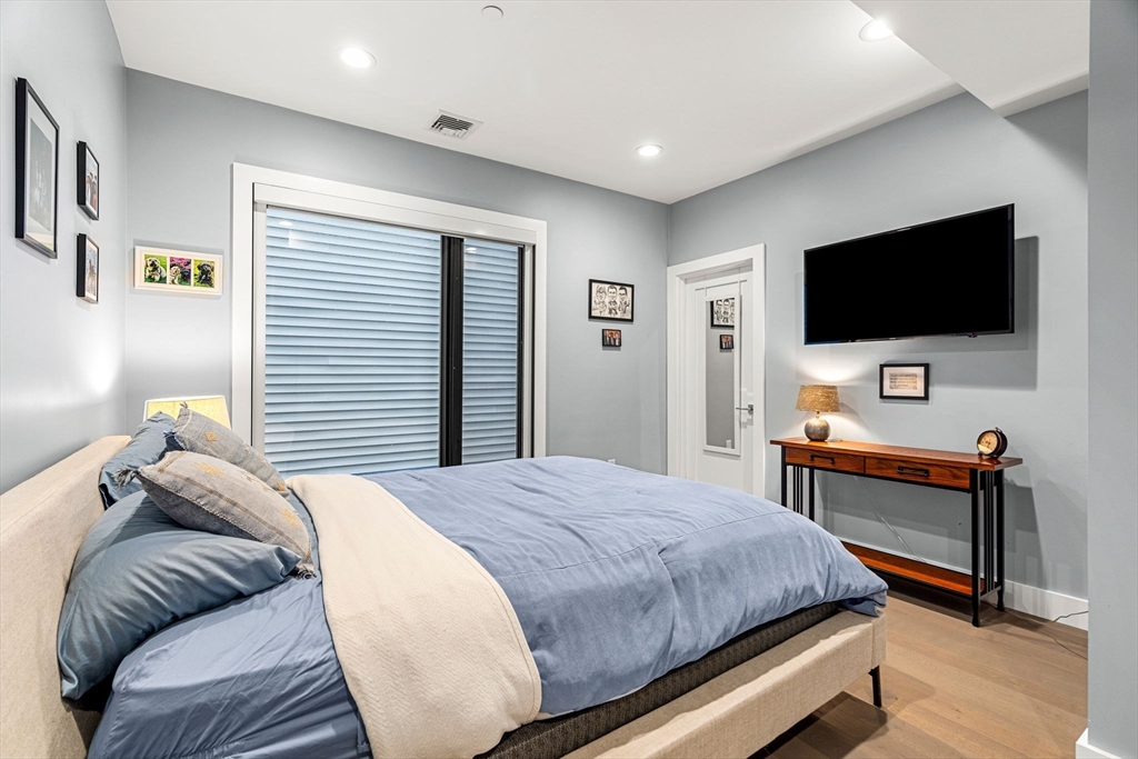 39 A Street, Unit 4 Boston, MA 02127 - Photo 14 of 28 a bedroom with a bed and a flat screen tv