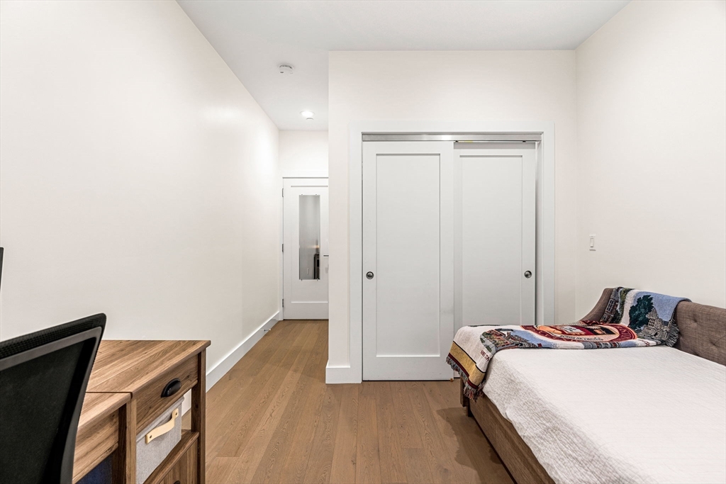 39 A Street, Unit 4 Boston, MA 02127 - Photo 17 of 28 a bedroom with a bed and a painting on the wall