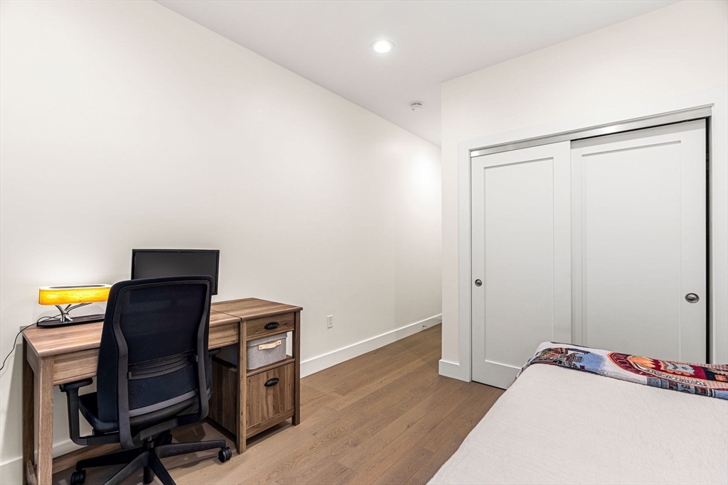 39 A Street, Unit 4 Boston, MA 02127 - Photo 18 of 28 a view of a workspace with furniture and wooden floor