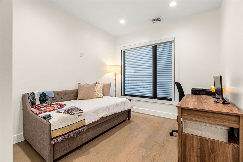 39 A Street, Unit 4 Boston, MA 02127 - Photo 19 of 28 a bedroom with a bed and a desk