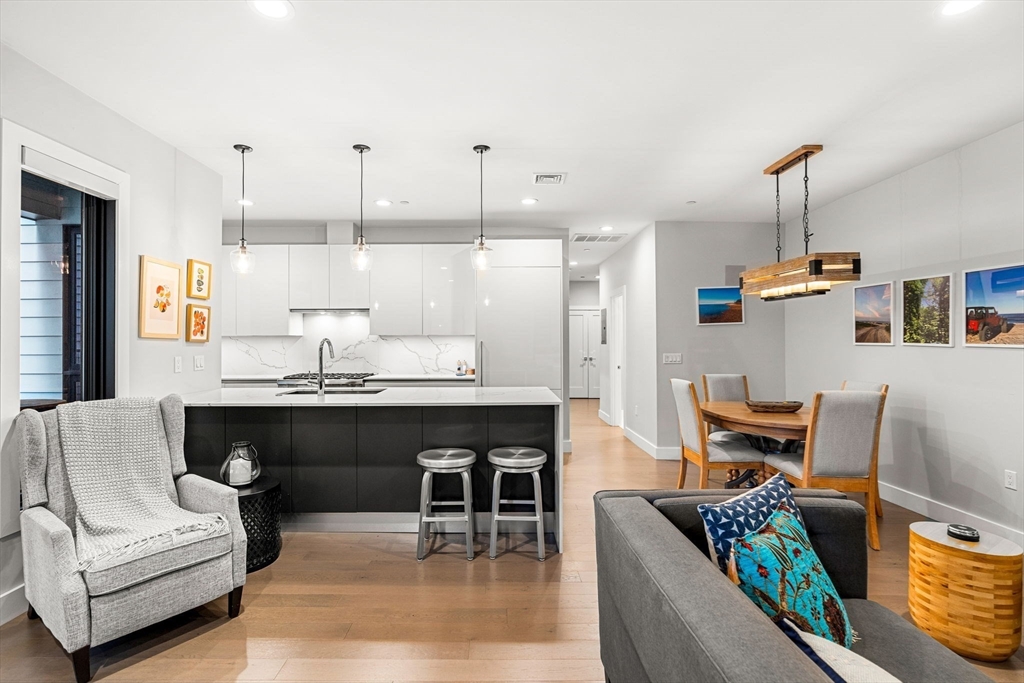 39 A Street, Unit 4 Boston, MA 02127 - Photo 2 of 28 a living room with furniture and kitchen view