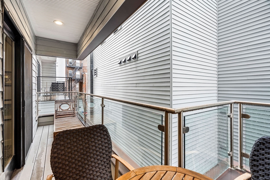 39 A Street, Unit 4 Boston, MA 02127 - Photo 24 of 28 a view of a balcony with wooden floor and furniture