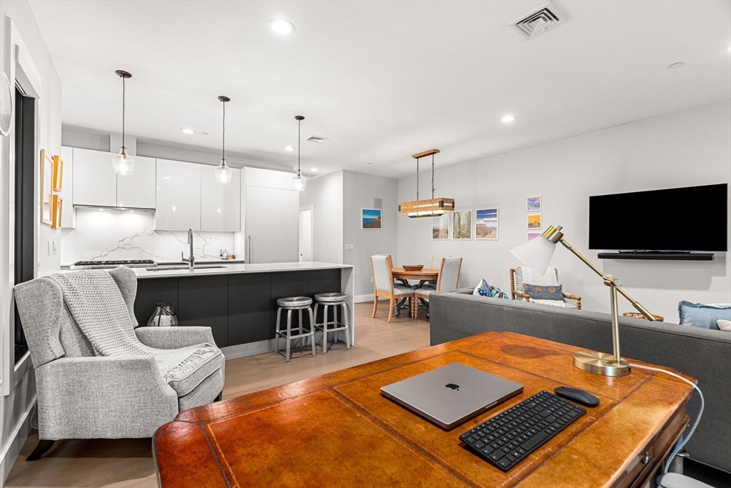 39 A Street, Unit 4 Boston, MA 02127 - Photo 3 of 28 a living room with furniture and a flat screen tv