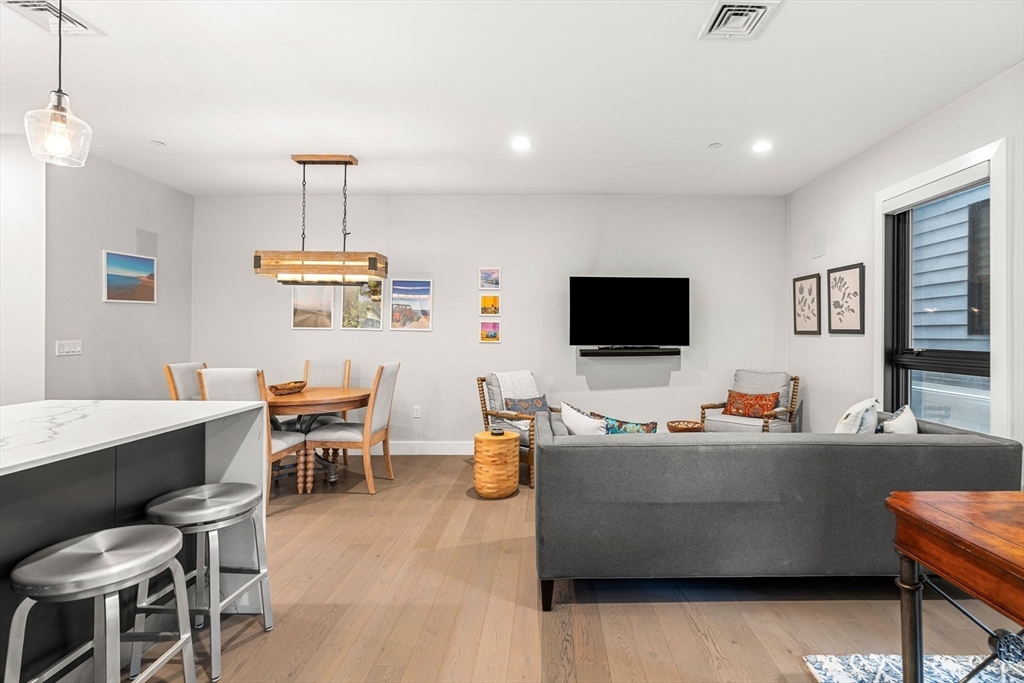 39 A Street, Unit 4 Boston, MA 02127 - Photo 4 of 28 a living room with furniture and a flat screen tv