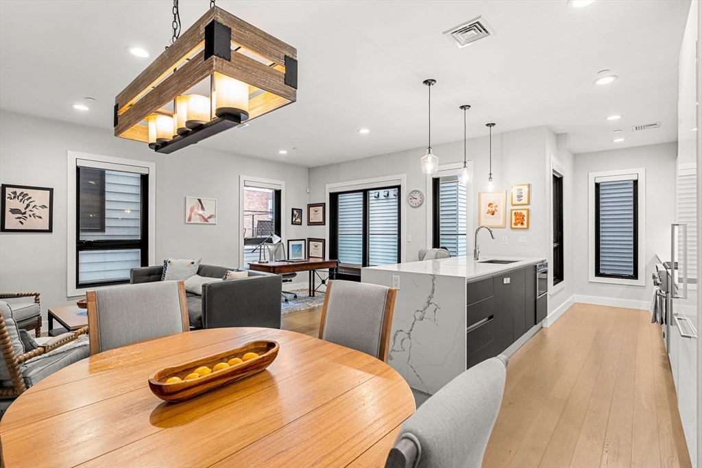 39 A Street, Unit 4 Boston, MA 02127 - Photo 7 of 28 a large kitchen with a table and chairs