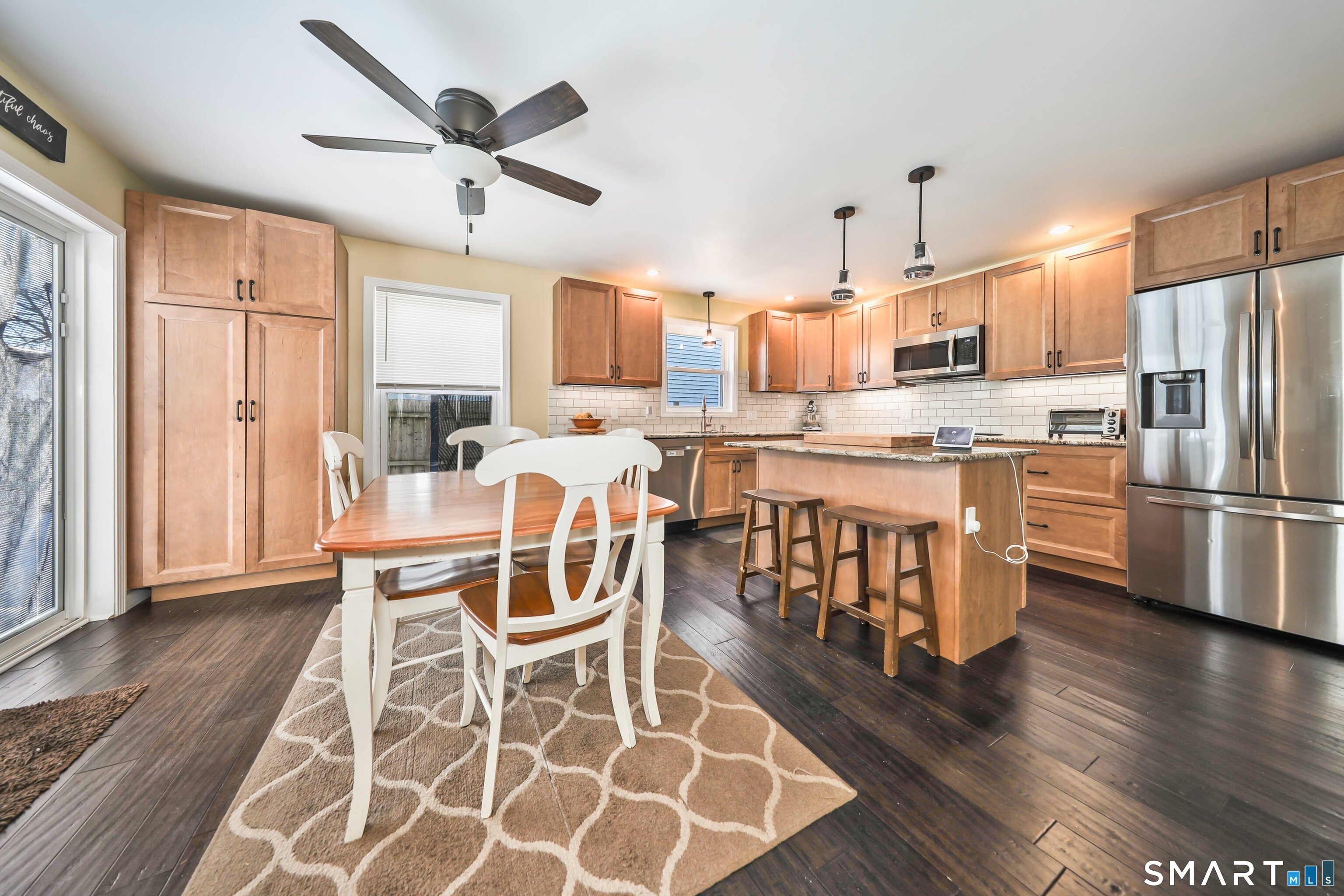 28 Beacon Street Beacon Falls, CT 06403 - Photo 16 of 38 a kitchen with stainless steel appliances a dining table chairs and wooden floor