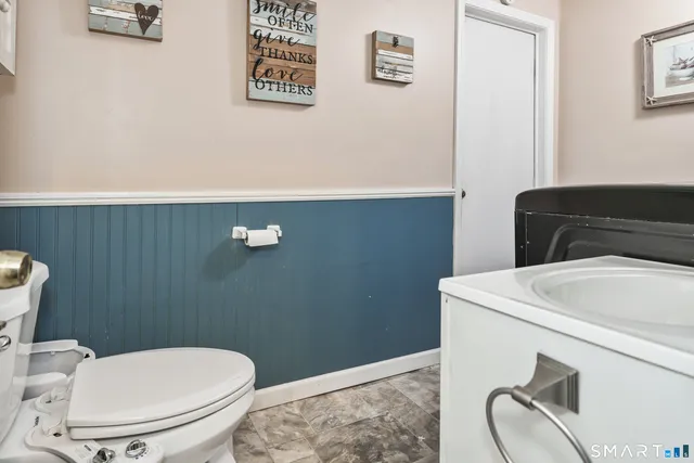 a white toilet sitting next to a bathroom sink