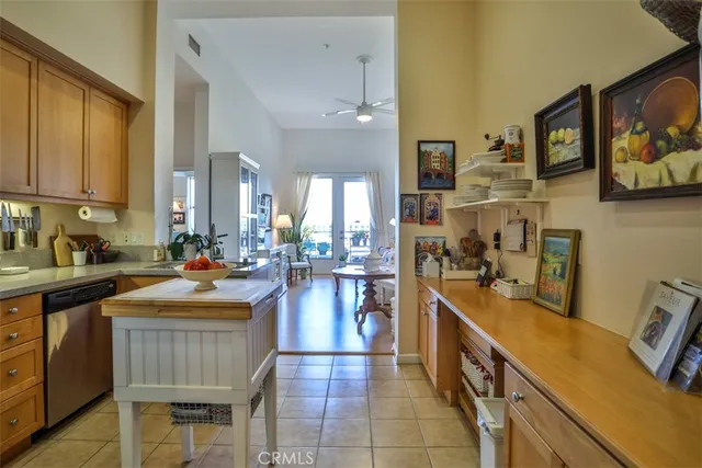 a kitchen with lots of counter top space and painting on the wall