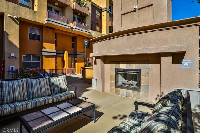 a view of a patio with couches table and chairs with wooden floor