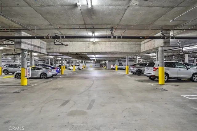 a view of parking garage with cars