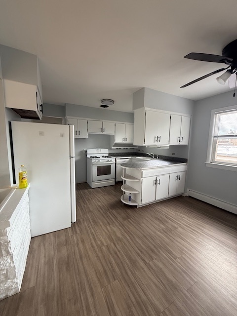 3537 South Harlem Avenue, Unit 2F Berwyn, IL 60402 - Photo 5 of 18 a kitchen with stainless steel appliances a white cabinets and wooden floors