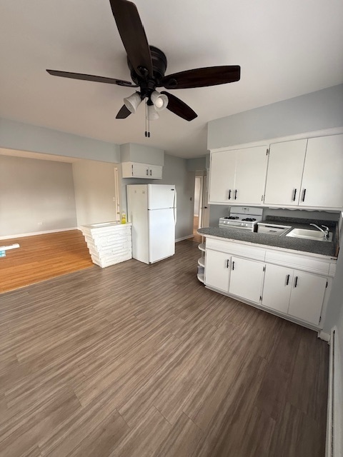 3537 South Harlem Avenue, Unit 2F Berwyn, IL 60402 - Photo 6 of 18 a kitchen with stainless steel appliances sink cabinets and wooden floor