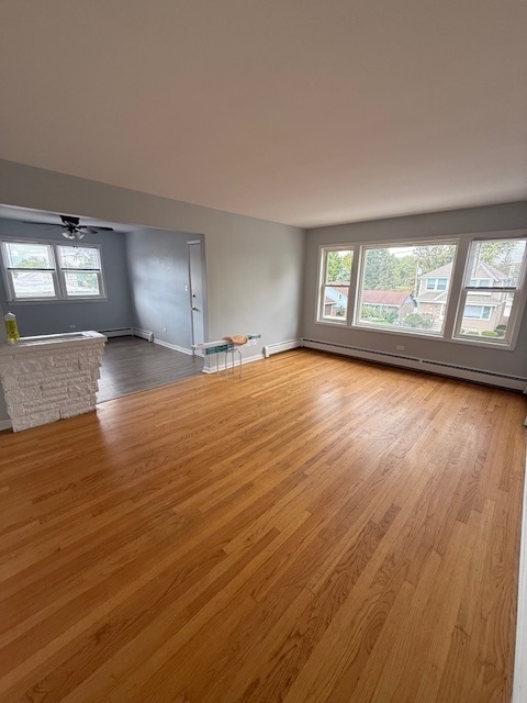 3537 South Harlem Avenue, Unit 2F Berwyn, IL 60402 - Photo 8 of 18 an empty room with wooden floor and windows