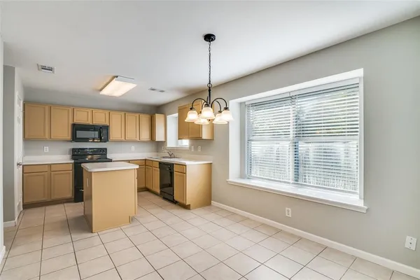 a kitchen with a refrigerator a sink dishwasher a oven with white cabinets and wooden floor