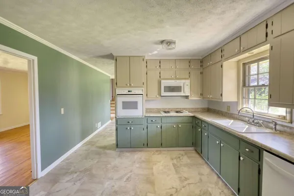 a kitchen with a sink cabinets and window