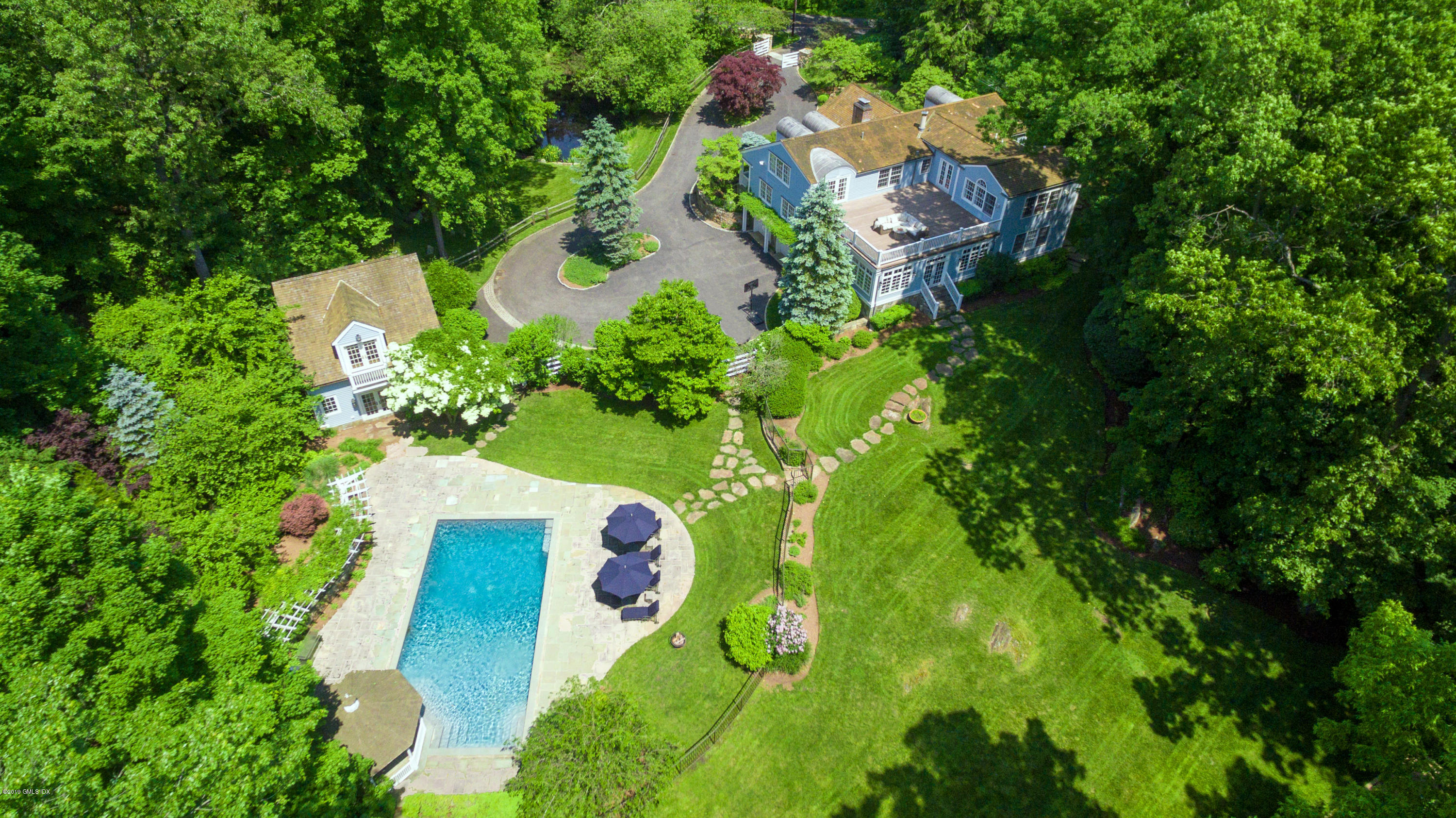 178 Cat Rock Road Cos Cob, CT 06807 - Photo 1 of 26 an aerial view of a house with a yard and trees