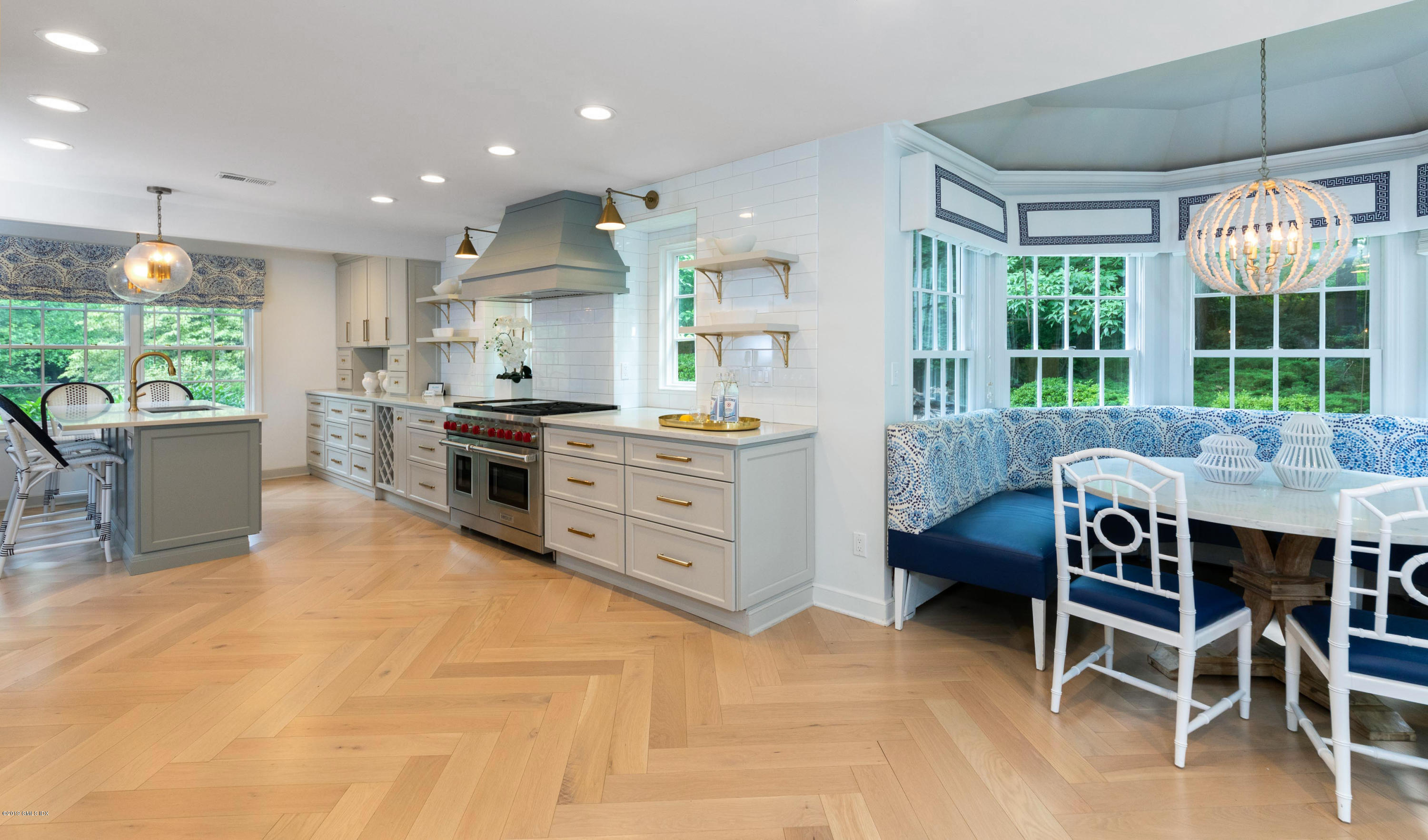 178 Cat Rock Road Cos Cob, CT 06807 - Photo 11 of 26 a kitchen with kitchen island a stove a table and chairs in it