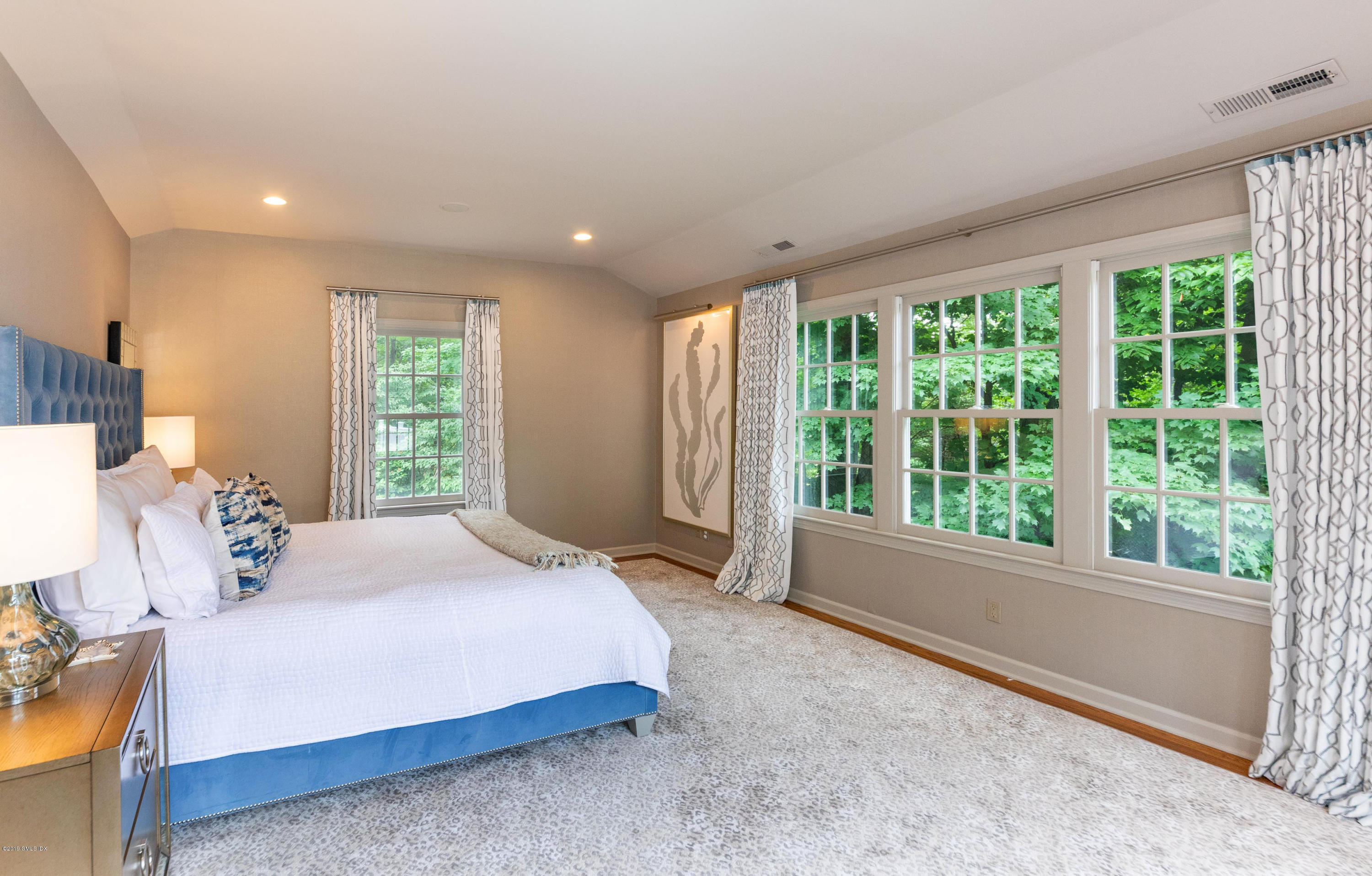 178 Cat Rock Road Cos Cob, CT 06807 - Photo 13 of 26 a bedroom with a large bed and a large window