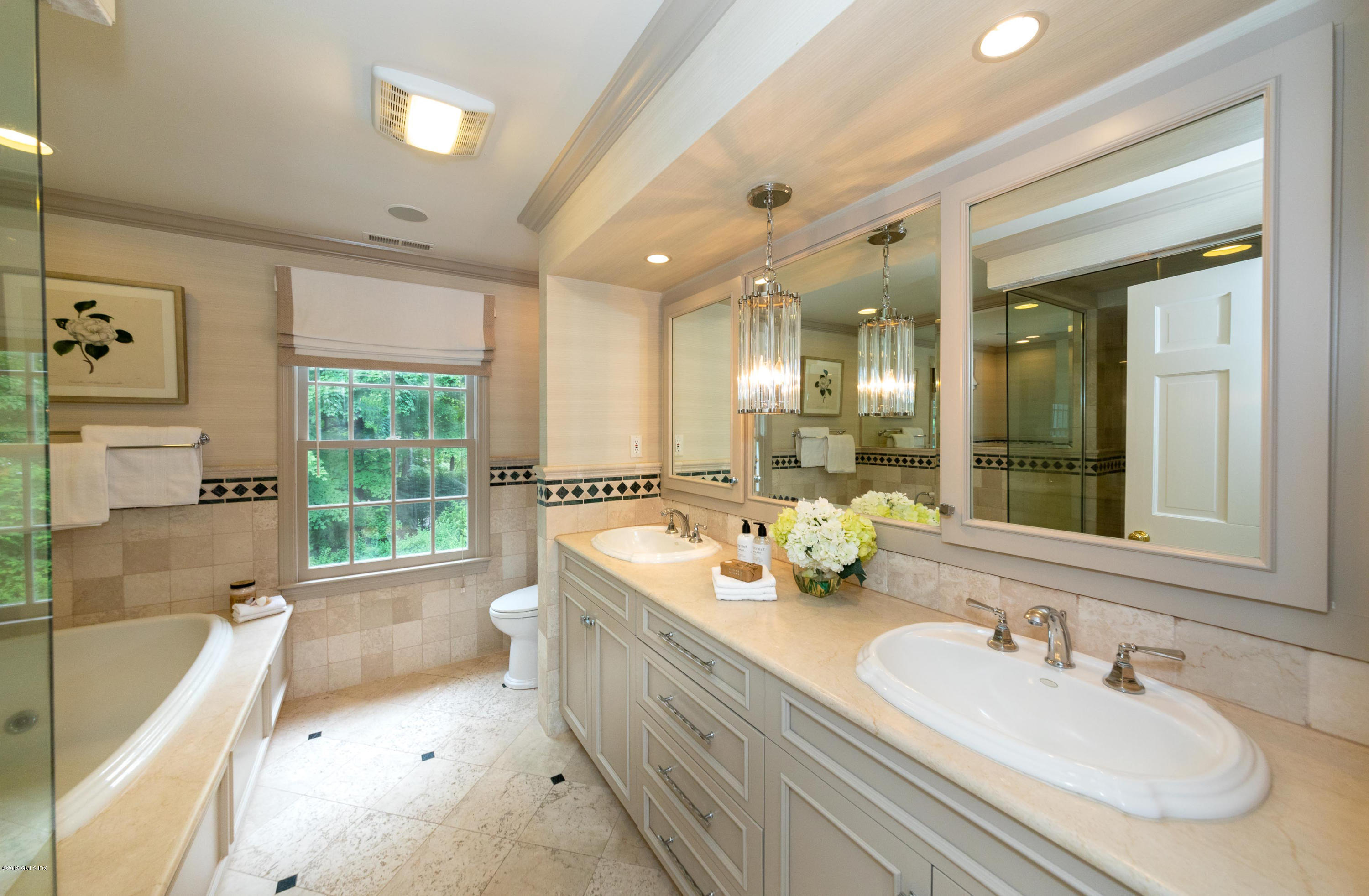 178 Cat Rock Road Cos Cob, CT 06807 - Photo 14 of 26 a spacious bathroom with a double vanity sink large mirror and a bathtub