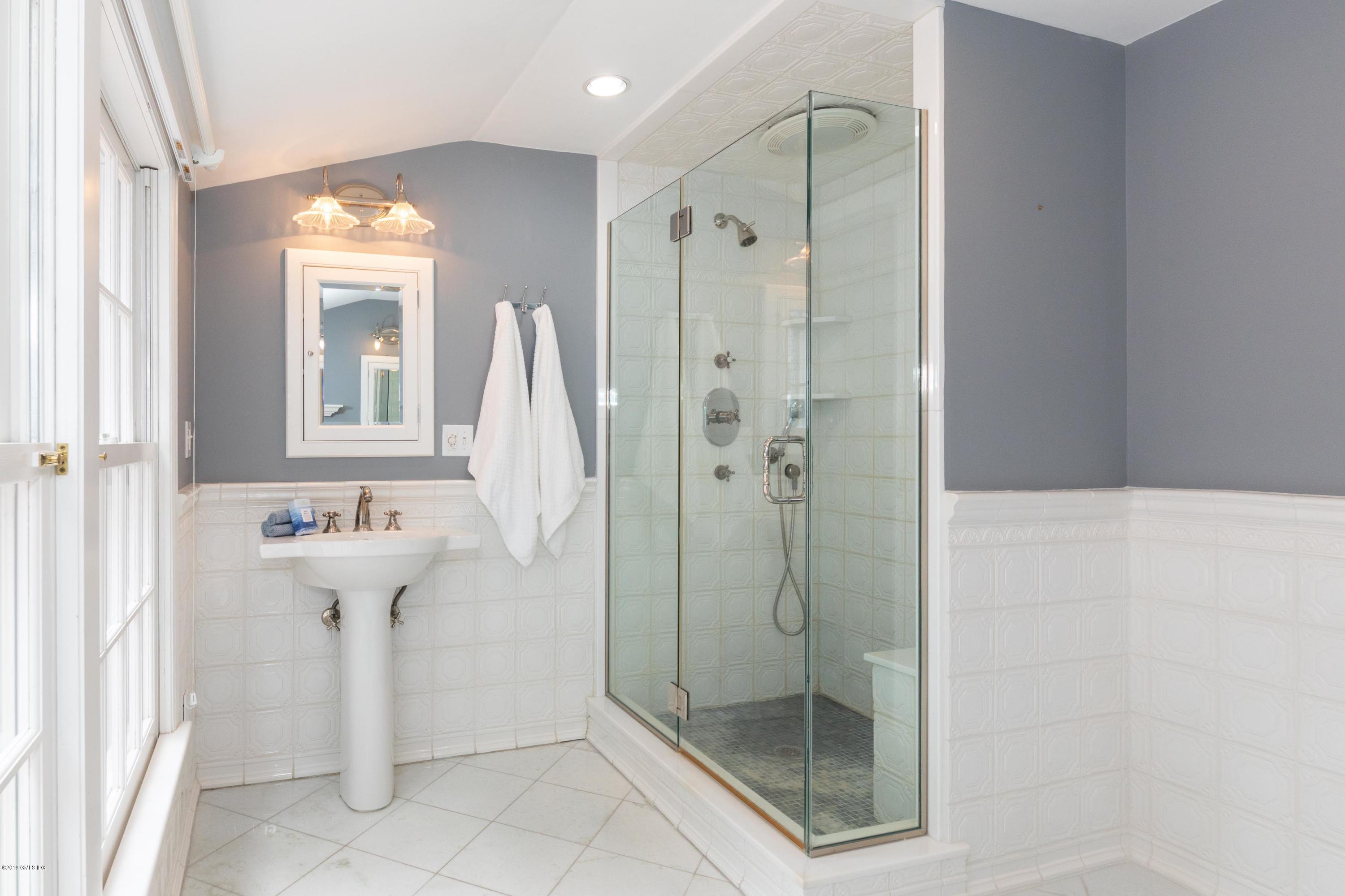 178 Cat Rock Road Cos Cob, CT 06807 - Photo 16 of 26 a bathroom with a shower and a sink