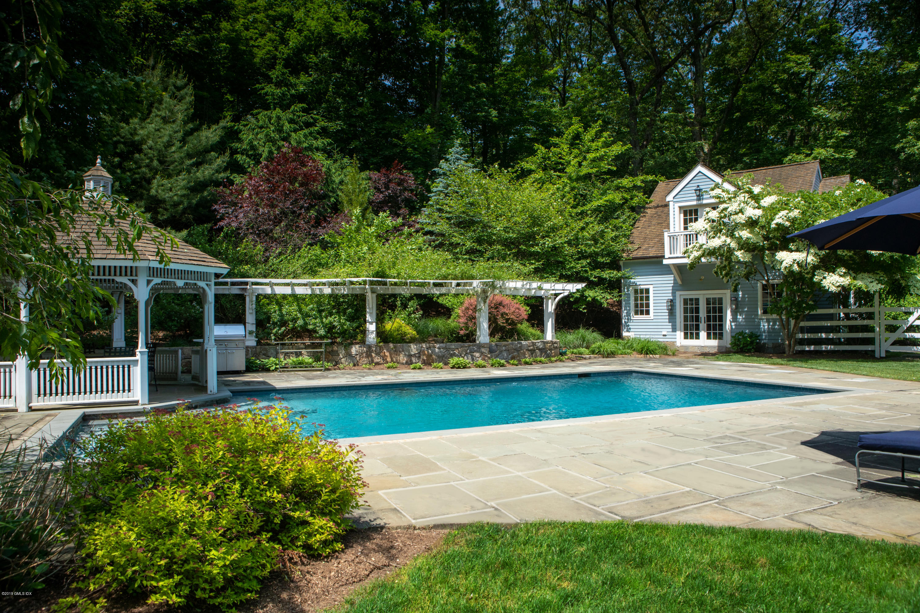 178 Cat Rock Road Cos Cob, CT 06807 - Photo 17 of 26 a view of pool with lawn chairs and large trees