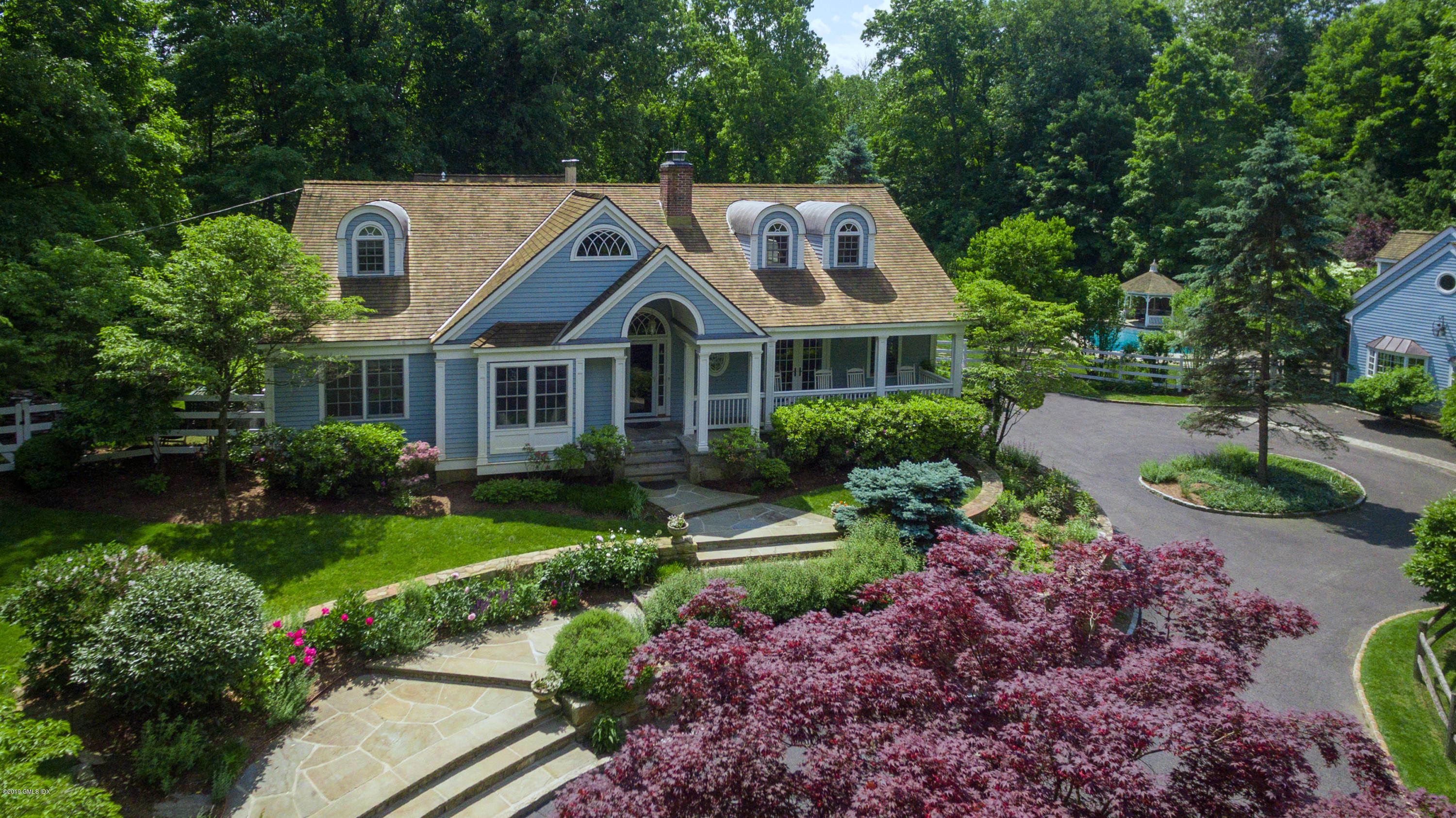 178 Cat Rock Road Cos Cob, CT 06807 - Photo 2 of 26 a front view of a house with a garden