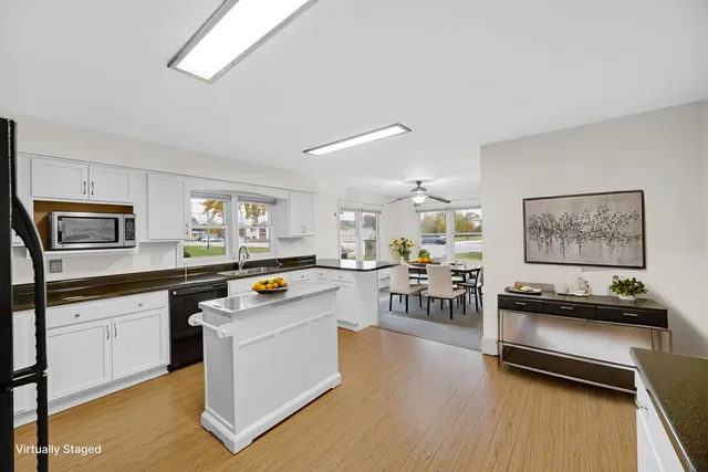 a kitchen with stainless steel appliances a stove a sink dishwasher and a refrigerator
