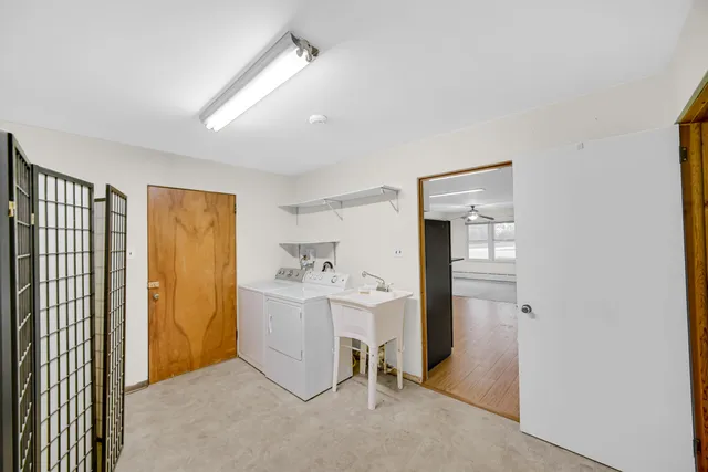 a view of a hallway with workspace and a window