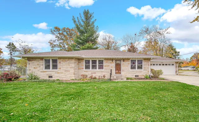 a front view of house with yard and green space