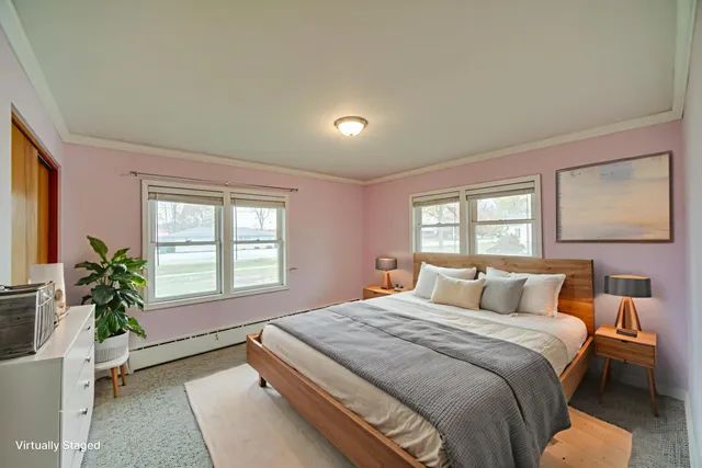 a bedroom with a large bed and a potted plant