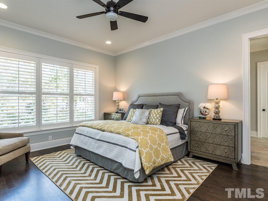 5216 Woodall Way, Unit 13 Raleigh, NC 27613 - Photo 12 of 25 a bedroom with a bed and a chandelier