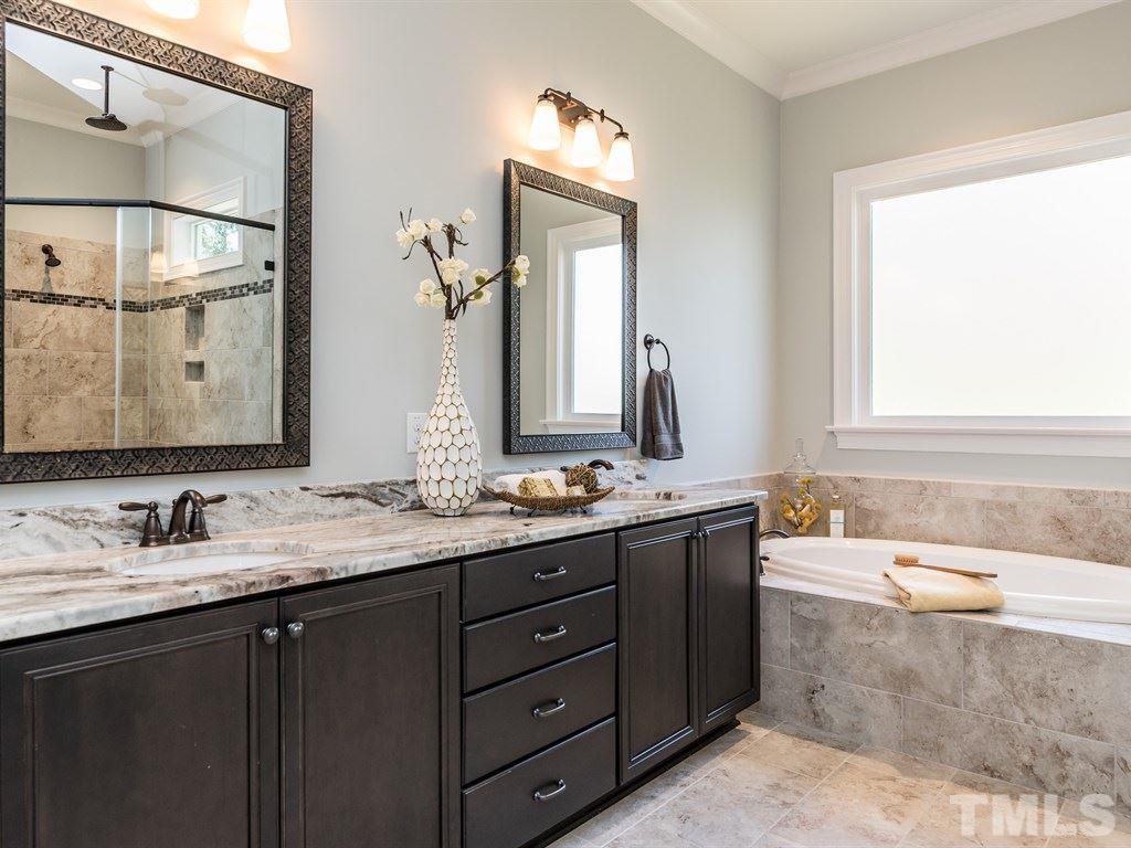 5216 Woodall Way, Unit 13 Raleigh, NC 27613 - Photo 13 of 25 a bathroom with a granite countertop tub sink and mirror