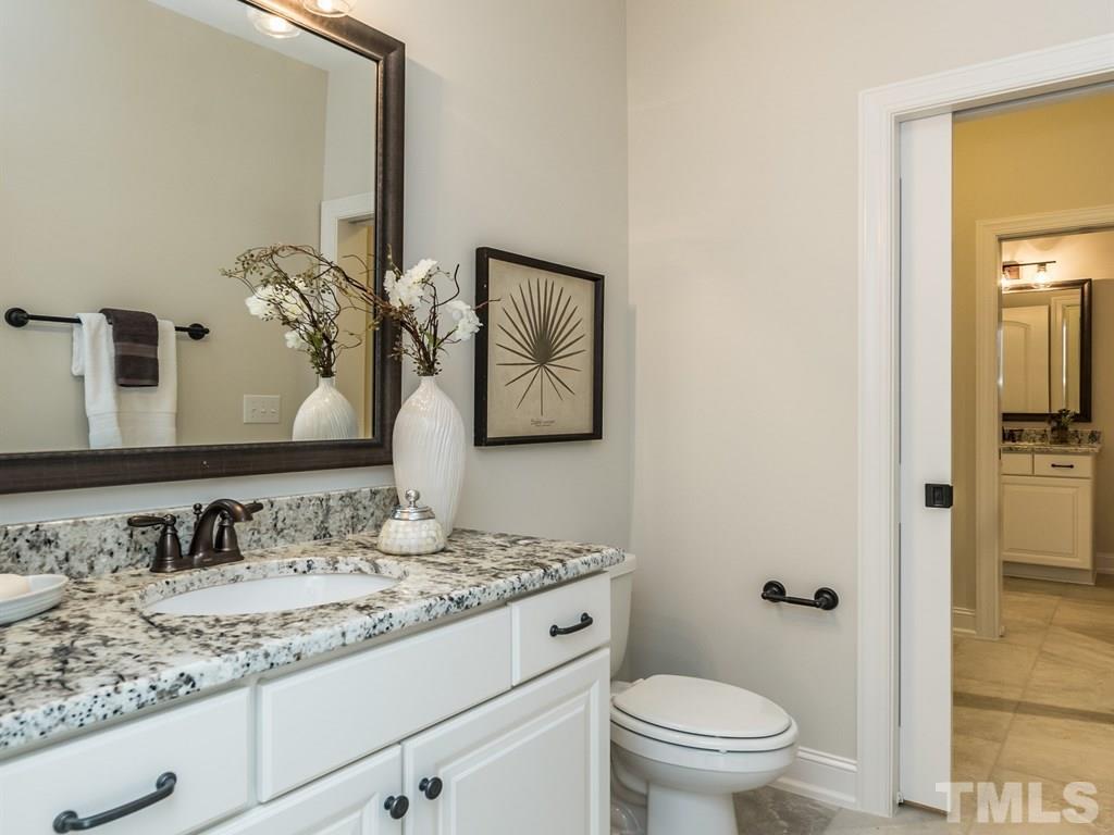 5216 Woodall Way, Unit 13 Raleigh, NC 27613 - Photo 18 of 25 a bathroom with a granite countertop sink toilet and mirror