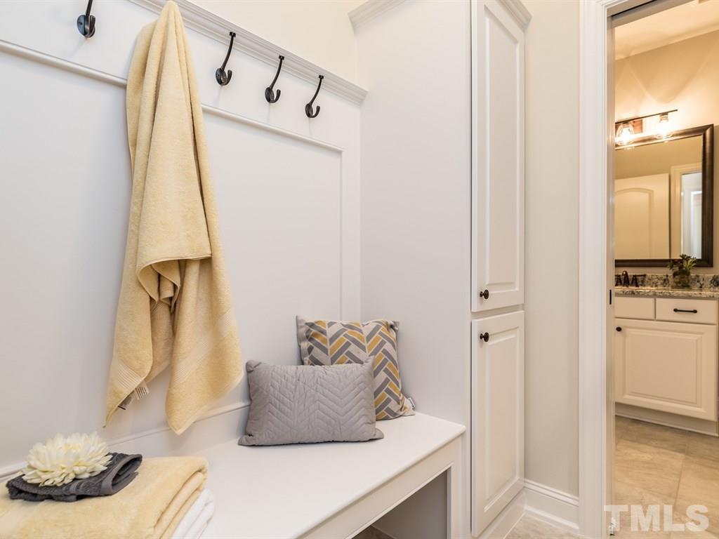 5216 Woodall Way, Unit 13 Raleigh, NC 27613 - Photo 19 of 25 a bedroom with a bed and a mirror