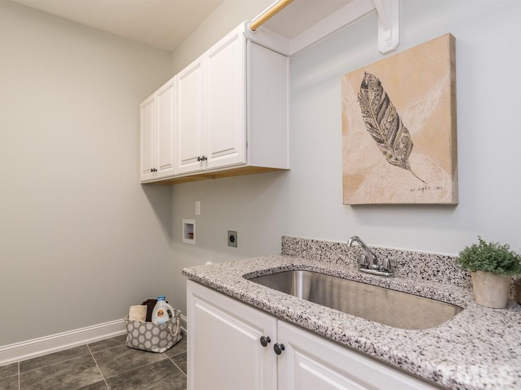 5216 Woodall Way, Unit 13 Raleigh, NC 27613 - Photo 20 of 25 a kitchen with granite countertop a sink and a stove