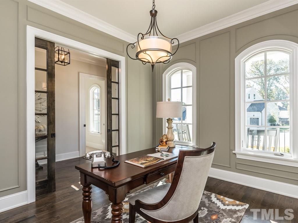 5216 Woodall Way, Unit 13 Raleigh, NC 27613 - Photo 4 of 25 a dining room with furniture a chandelier and wooden floor
