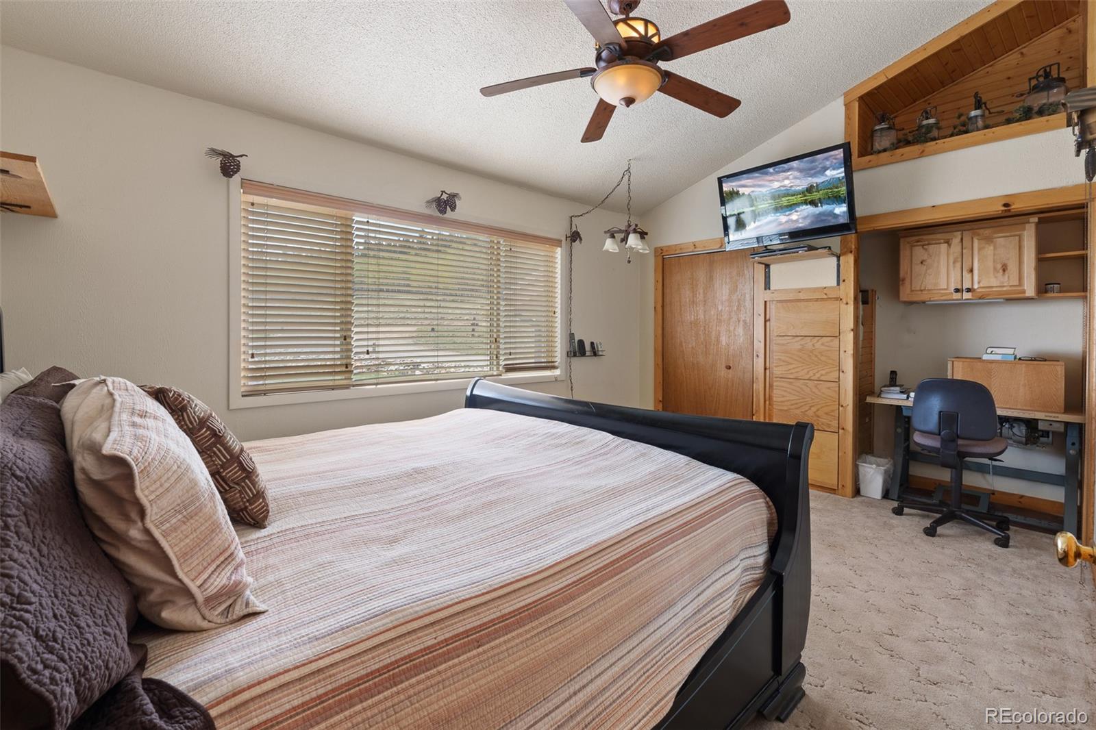 1163 Michigan Hill Road Jefferson, CO 80456 - Photo 33 of 48 a bedroom with a bed couch and a window