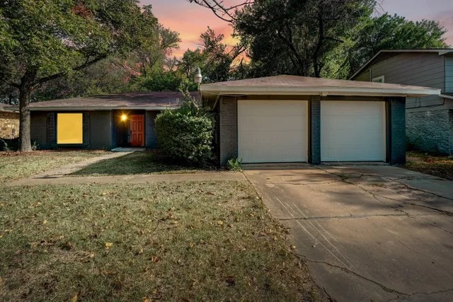 a front view of house with yard and trees