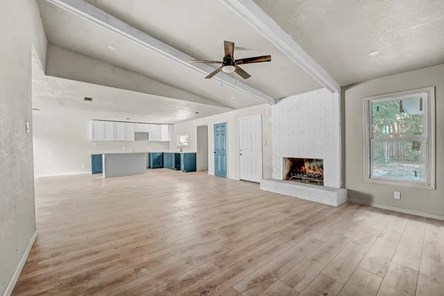 a view of a livingroom with a fireplace and window