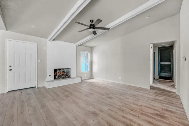 wooden floor in an empty room with a window