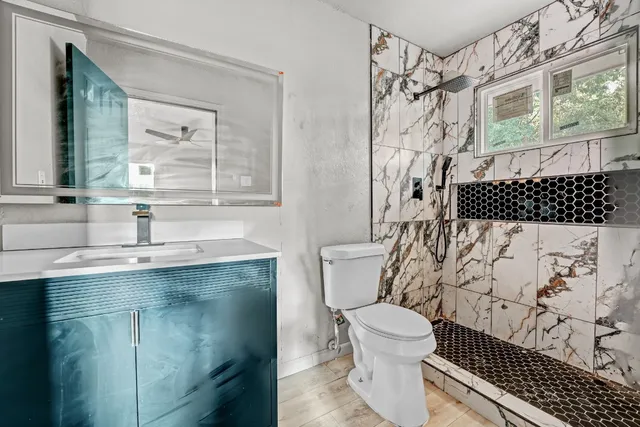 a bathroom with a sink toilet and shower