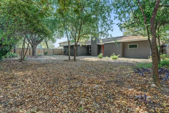 a house that has a tree in front of it